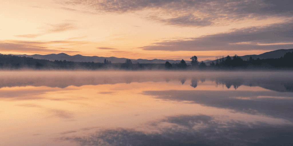 serene image of nature with a sunset sky and trees in the background showing still reflection, selling less reaching more